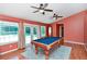 Bright game room with a pool table, ceiling fans, and an entrance to the patio at 682 Ferncliff Dr, Port Orange, FL 32127
