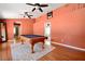 Pool table in an airy recreation room with bright walls and ceiling fans at 682 Ferncliff Dr, Port Orange, FL 32127