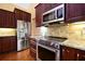 Chef's kitchen with stainless appliances, granite counters, and ample cabinet space for storage at 682 Ferncliff Dr, Port Orange, FL 32127