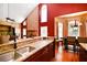 Open-concept kitchen with granite countertops, stainless steel appliances, and hardwood flooring at 682 Ferncliff Dr, Port Orange, FL 32127