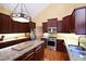 Well-equipped kitchen features stainless steel appliances, granite countertops, and hardwood floors at 682 Ferncliff Dr, Port Orange, FL 32127