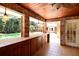 Enclosed outdoor bar area overlooking the pool and yard; features tiled flooring and brick at 682 Ferncliff Dr, Port Orange, FL 32127