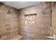 Modern walk-in shower with wood-look tile, dual shower heads, and a built-in bench at 682 Ferncliff Dr, Port Orange, FL 32127