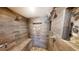 Modern shower featuring wood-like tiles, dual shower heads, and pebble-filled niches at 682 Ferncliff Dr, Port Orange, FL 32127