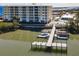 Aerial view of a condo complex with a boat dock and waterfront access. Swimming pool visible at 7 Riverwalk Dr # 205, New Smyrna Beach, FL 32169