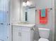 Bright bathroom features a white vanity with a granite countertop and a mirror with modern lighting at 7 Riverwalk Dr # 205, New Smyrna Beach, FL 32169