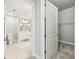 An open view of a bathroom and closet featuring neutral tones, a double sink, and a toilet at 7 Riverwalk Dr # 205, New Smyrna Beach, FL 32169