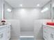 Bright, modern bathroom with a spacious shower and glass enclosure, flanked by dual vanities at 7 Riverwalk Dr # 205, New Smyrna Beach, FL 32169