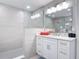 Bathroom featuring a vanity, spacious shower with glass enclosure, and modern lighting at 7 Riverwalk Dr # 205, New Smyrna Beach, FL 32169