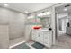 Bright bathroom featuring neutral tones, a vanity, and a glass-door shower at 7 Riverwalk Dr # 205, New Smyrna Beach, FL 32169