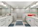 A spacious bathroom featuring dual sinks, a glass-enclosed shower, and neutral tones at 7 Riverwalk Dr # 205, New Smyrna Beach, FL 32169