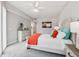 Relaxing bedroom featuring a comfy bed with colorful pillows, a dresser, and neutral décor at 7 Riverwalk Dr # 205, New Smyrna Beach, FL 32169