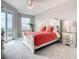 Bright bedroom featuring a plush bed, ceiling fan, and sliding glass doors to a private balcony at 7 Riverwalk Dr # 205, New Smyrna Beach, FL 32169