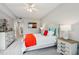 Bright bedroom featuring neutral colors, an inviting white bed with colorful accents, and charming bedside tables at 7 Riverwalk Dr # 205, New Smyrna Beach, FL 32169