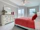 Sunny bedroom featuring a dresser, an outdoor balcony, and neutral-toned walls at 7 Riverwalk Dr # 205, New Smyrna Beach, FL 32169