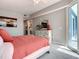 Bright bedroom with a dresser, mirror, and a sliding door to the balcony with outside views at 7 Riverwalk Dr # 205, New Smyrna Beach, FL 32169