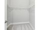 A well-organized, empty walk-in closet with white wire shelving and neutral carpeting at 7 Riverwalk Dr # 205, New Smyrna Beach, FL 32169