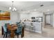 Charming dining area adjacent to a modern kitchen with stainless steel appliances and bar seating under elegant lighting at 7 Riverwalk Dr # 205, New Smyrna Beach, FL 32169