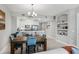 Stylish dining area flows into a modern kitchen, featuring stainless steel appliances and elegant decor, creating inviting ambiance at 7 Riverwalk Dr # 205, New Smyrna Beach, FL 32169