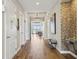 Hallway featuring tiled floors and decorative accents with views of a community seating area and chandeliers at 7 Riverwalk Dr # 205, New Smyrna Beach, FL 32169
