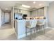 Bright kitchen with stainless steel appliances, gray cabinets, breakfast bar, and seating at 7 Riverwalk Dr # 205, New Smyrna Beach, FL 32169