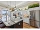 Community kitchen area featuring stone countertops, stainless steel refrigerator, and an island with barstool seating at 7 Riverwalk Dr # 205, New Smyrna Beach, FL 32169