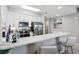 Contemporary kitchen with white cabinets, stainless steel appliances, granite countertops, and breakfast bar at 7 Riverwalk Dr # 205, New Smyrna Beach, FL 32169