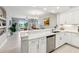 Kitchen with granite counters, stainless steel appliances, a breakfast bar, and an open view into the living area at 7 Riverwalk Dr # 205, New Smyrna Beach, FL 32169