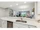 Kitchen with granite counters, stainless steel appliances, a breakfast bar, and an open view into the living area at 7 Riverwalk Dr # 205, New Smyrna Beach, FL 32169