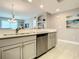 Modern kitchen featuring stainless steel appliances, light gray cabinetry, and bright lighting at 7 Riverwalk Dr # 205, New Smyrna Beach, FL 32169