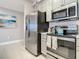 Close-up of a modern kitchen with stainless steel appliances, gray cabinets, and stylish finishes at 7 Riverwalk Dr # 205, New Smyrna Beach, FL 32169