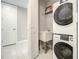 Well-equipped laundry room with a stacked washer and dryer and a utility sink at 7 Riverwalk Dr # 205, New Smyrna Beach, FL 32169