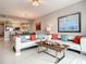 Bright living room with modern furnishings and an open concept design to the kitchen at 7 Riverwalk Dr # 205, New Smyrna Beach, FL 32169