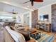 Lounge area with wood floors and a stacked stone accent wall that houses the TV and Entertainment Center at 7 Riverwalk Dr # 205, New Smyrna Beach, FL 32169