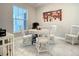 Stylish office space with a round table, white chairs, and large window for natural light at 7 Riverwalk Dr # 205, New Smyrna Beach, FL 32169