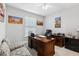 Office room featuring a dark wooden desk, office chair, and a window with blinds at 7 Riverwalk Dr # 205, New Smyrna Beach, FL 32169