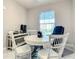 Bright office space with a round table and chairs with views of the cityscape beyond at 7 Riverwalk Dr # 205, New Smyrna Beach, FL 32169