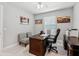 Office room featuring a dark wooden desk, office chair, and a window with blinds at 7 Riverwalk Dr # 205, New Smyrna Beach, FL 32169