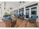 Comfortable outdoor seating area on a covered patio with tile floor and view of the pool at 7 Riverwalk Dr # 205, New Smyrna Beach, FL 32169