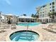 The pool area features a jacuzzi, swimming pool, lounge chairs, covered seating areas, and views of the surrounding buildings at 7 Riverwalk Dr # 205, New Smyrna Beach, FL 32169