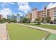 Community recreation area including a shuffleboard court surrounded by palm trees, parking, and multi-story condo buildings at 7 Riverwalk Dr # 205, New Smyrna Beach, FL 32169