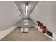 Unfinished attic space with exposed insulation, lighting, and a single window at 706 S Timberlane Dr, New Smyrna Beach, FL 32168