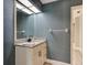 Charming bathroom featuring a vanity with a granite countertop and a decorative mirror at 706 S Timberlane Dr, New Smyrna Beach, FL 32168