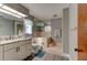 Well-appointed bathroom with a shower-tub combo, vanity, and ample storage at 706 S Timberlane Dr, New Smyrna Beach, FL 32168