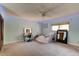 Bedroom with carpeted floors, ceiling fan, vanity, bed, and a view to the backyard at 706 S Timberlane Dr, New Smyrna Beach, FL 32168