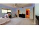 Bedroom with carpeted floors, ceiling fan, bed, dresser, and access to the bathroom at 706 S Timberlane Dr, New Smyrna Beach, FL 32168
