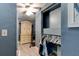 Walk-in closet with clothes, shelving, storage, and hardwood floors under a ceiling fan and light fixture at 706 S Timberlane Dr, New Smyrna Beach, FL 32168