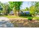 Charming two-story brick home with lush landscaping and mature trees, creating a serene and private setting at 706 S Timberlane Dr, New Smyrna Beach, FL 32168