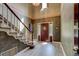 Elegant foyer features high ceilings, stylish wallpaper, a grand staircase, and wood-look floors, making a lasting impression at 706 S Timberlane Dr, New Smyrna Beach, FL 32168