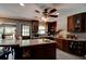 Spacious kitchen with custom wood cabinetry, an island, and a charming brick archway detail at 706 S Timberlane Dr, New Smyrna Beach, FL 32168